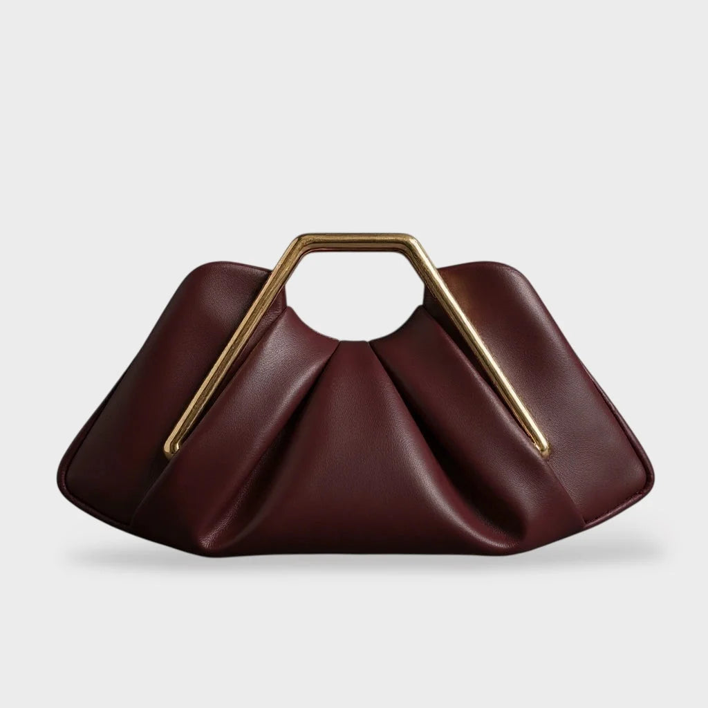 Stylish leather clutch bag featuring a gold handle, origami-inspired design, and a spacious interior made from high-quality microfiber leather. 7