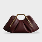 Stylish leather clutch bag featuring a gold handle, origami-inspired design, and a spacious interior made from high-quality microfiber leather. 7