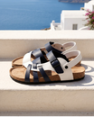 Leather sandals featuring an adjustable ankle strap and comfortable cork footbed, designed with a stylish multi-strap design suitable for both men and women. 0