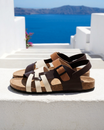 Leather sandals featuring an adjustable ankle strap and comfortable cork footbed, designed with a stylish multi-strap design suitable for both men and women. 1