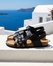 Leather sandals featuring an adjustable ankle strap and comfortable cork footbed, designed with a stylish multi-strap design suitable for both men and women. 2