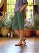 Linen capri pants featuring a V-notch waistband and convenient side pockets, designed for a relaxed fit perfect for warm days. 3