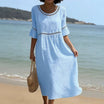 Linen midi dress featuring hollow out detail and flared sleeves, perfect for a relaxed summer look in warm weather. 1