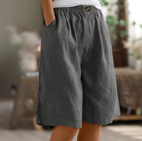 Linen shorts with elastic waist and deep side pockets, featuring a breathable relaxed fit perfect for both men and women. 1
