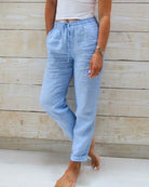Linen trousers with drawstring waist and straight leg, featuring a relaxed fit and cropped design, perfect for women's summer fashion in white. 0