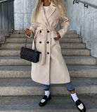 Long wool coat for women featuring a double-breasted design in classic black, tailored fit for a stylish and sophisticated look. 2