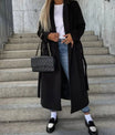 Long wool coat for women featuring a double-breasted design in classic black, tailored fit for a stylish and sophisticated look. 3