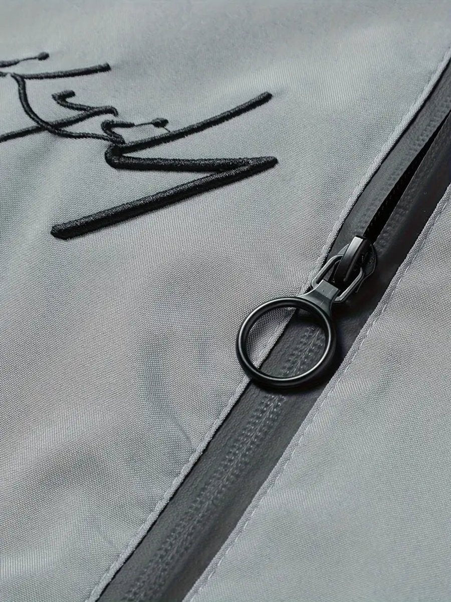 Men's black polyester bomber jacket featuring a zip-up front, baseball collar, and stylish embroidered detail. 1