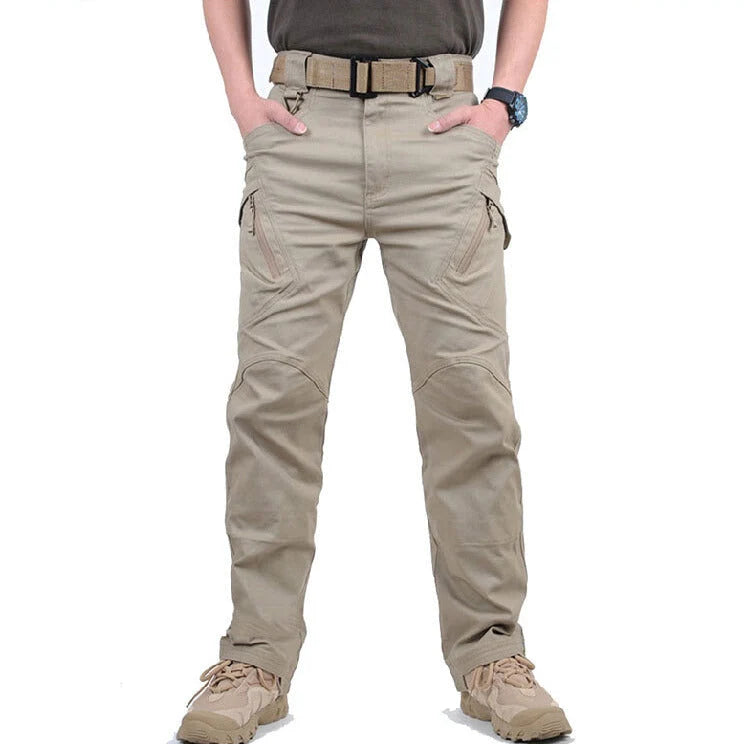 Men's black cargo pants featuring multiple pockets and reinforced seams, designed for hiking and outdoor activities. 1