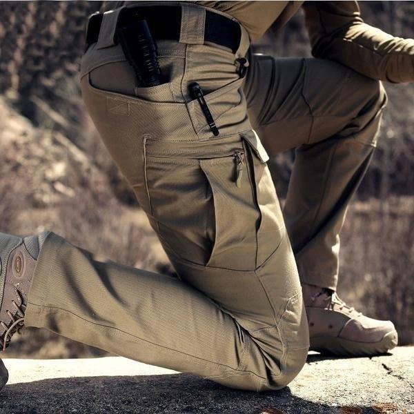Men's black cargo pants featuring multiple pockets and reinforced seams, designed for hiking and outdoor activities. 2