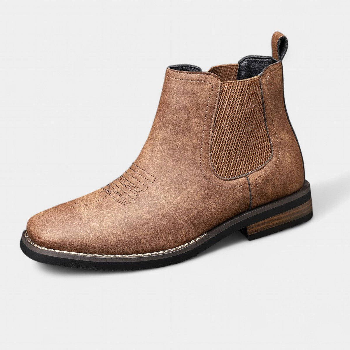 Men's tan faux leather Chelsea boots featuring elastic side panels and western stitching, perfect for stylish casual wear. 1
