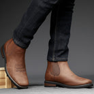 Men's tan faux leather Chelsea boots featuring elastic side panels and western stitching, perfect for stylish casual wear. 2