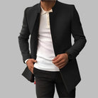 Men's collarless black wool overcoat featuring an open front design and a slim fit silhouette, perfect for a stylish and modern look. 4