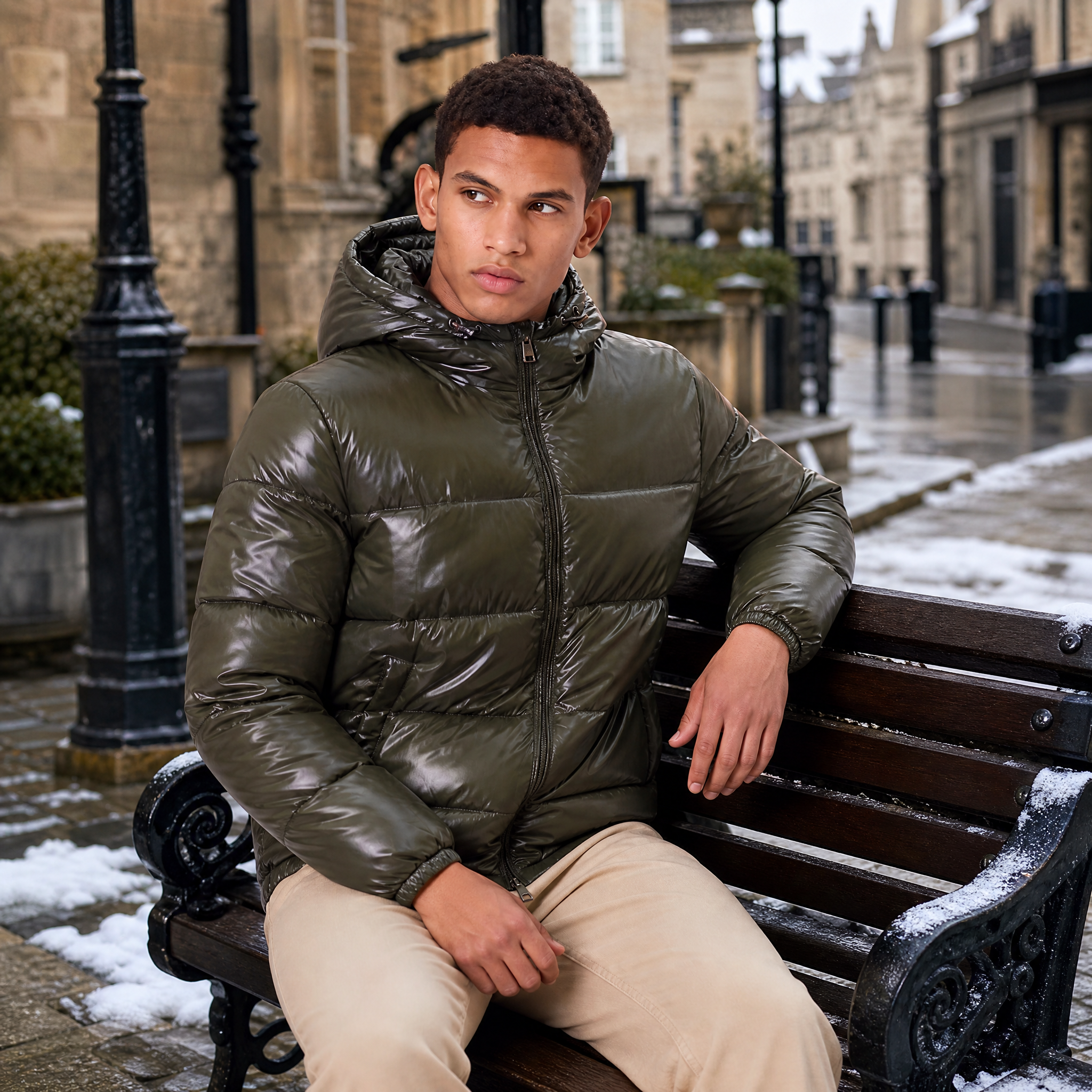 Men's hooded puffer jacket featuring zip pockets and a glossy quilted finish, designed for a relaxed fit, perfect for winter wear. 1