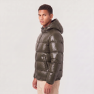 Men's hooded puffer jacket featuring zip pockets and a glossy quilted finish, designed for a relaxed fit, perfect for winter wear. 4