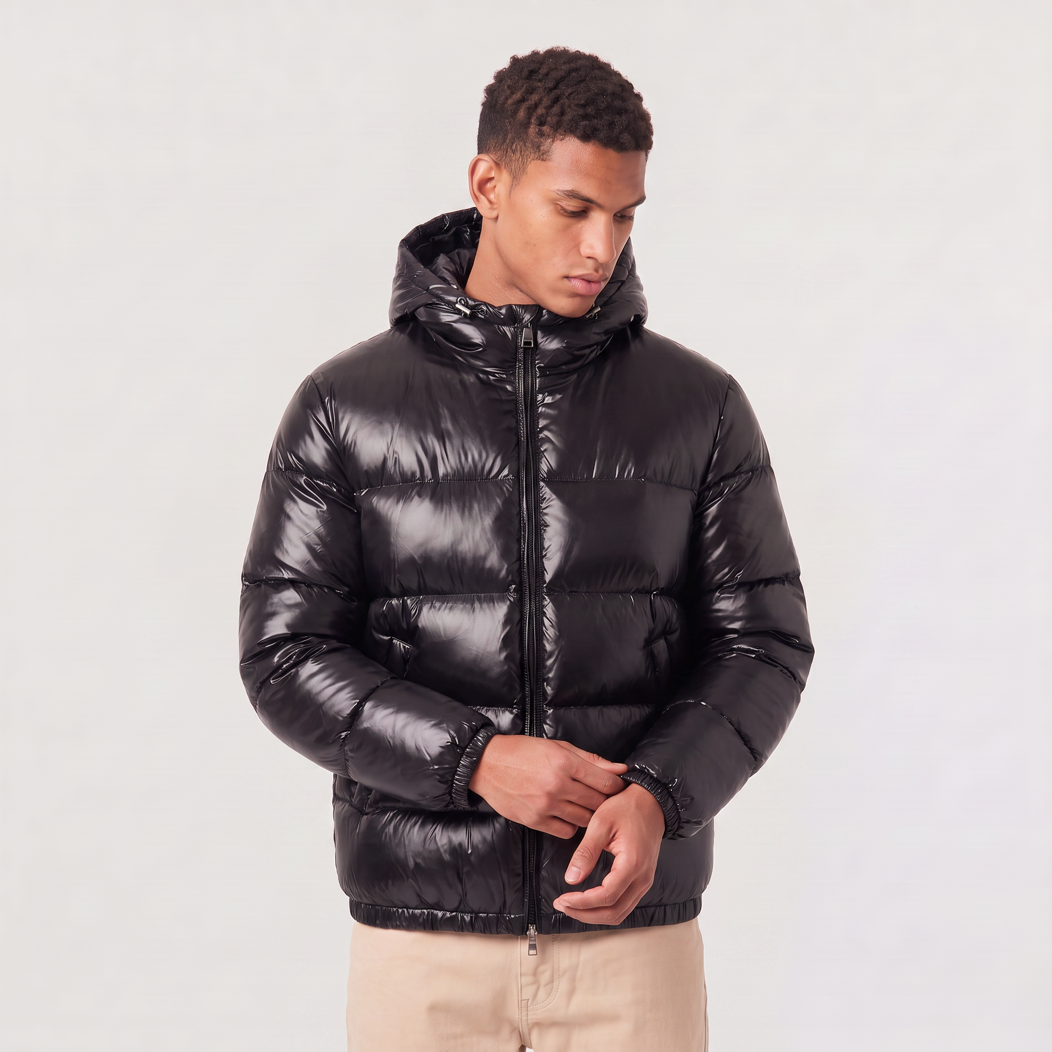 Men's hooded puffer jacket featuring zip pockets and a glossy quilted finish, designed for a relaxed fit, perfect for winter wear. 5