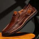 Men's leather slip-on loafers featuring a cushioned insole and a glossy finish, ideal for both casual and formal occasions. 2