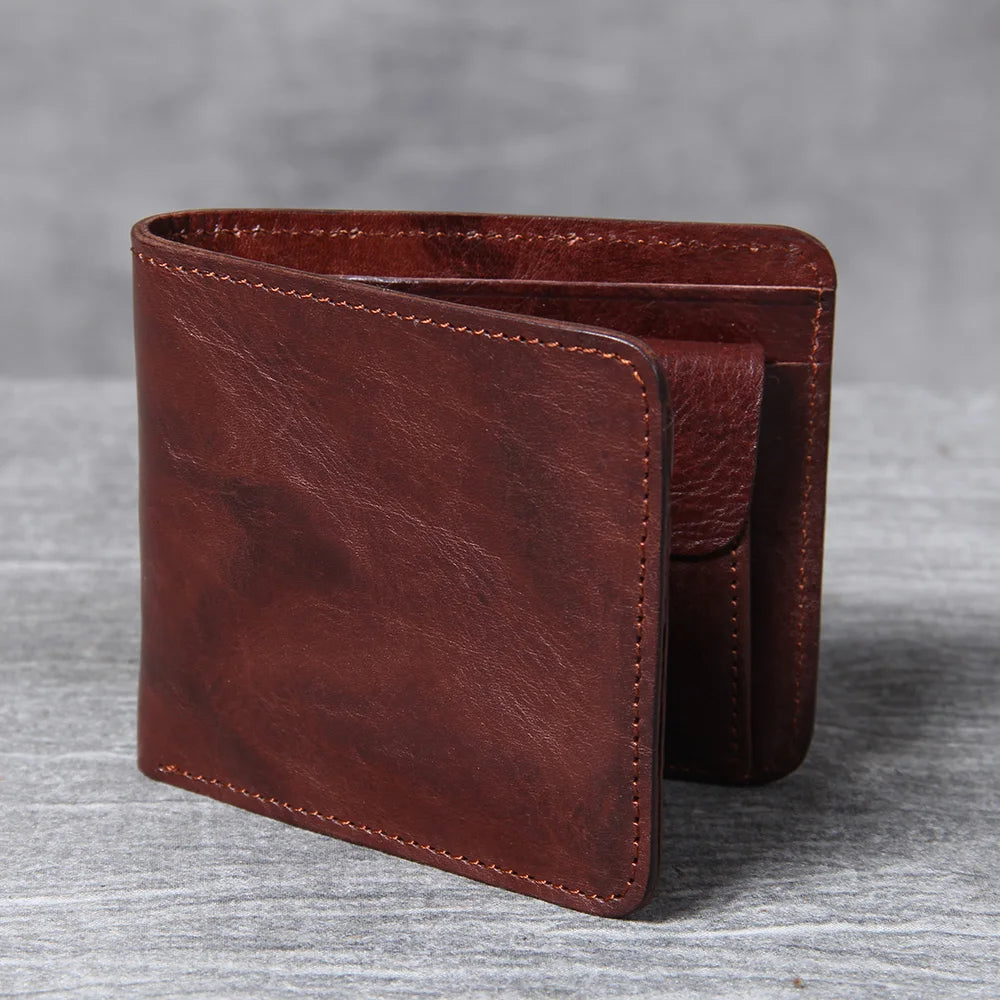 Men's leather wallet featuring a slim bi-fold design, durable cowhide material, and a convenient snap coin pocket, ideal for stylish and organized storage. 1