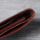 Men's leather wallet featuring a slim bi-fold design, durable cowhide material, and a convenient snap coin pocket, ideal for stylish and organized storage. 3