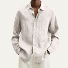 Men's long sleeve button-up shirt featuring a relaxed fit and smooth woven fabric, available in multiple colors for versatile styling. 0