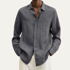 Men's long sleeve button-up shirt featuring a relaxed fit and smooth woven fabric, available in multiple colors for versatile styling. 2