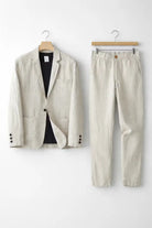 Men's suit set featuring a relaxed fit blazer and trousers made from breathable linen fabric, perfect for versatile formal and casual occasions. 1