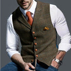Men's tailored slim-fit herringbone tweed vest gilet featuring stylish wooden buttons, perfect for smart casual or formal wear. 1