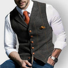 Men's tailored slim-fit herringbone tweed vest gilet featuring stylish wooden buttons, perfect for smart casual or formal wear. 2