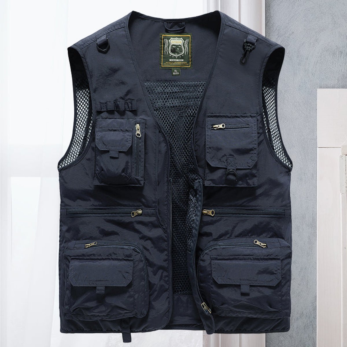 Men's lightweight polyester vest featuring a breathable mesh back and multi-pocket design, ideal for outdoor activities such as hiking, camping, and fishing. 12
