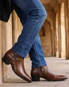 Men's black ankle boots featuring a stylish harness strap and pointed toe, crafted from polished leather for a sleek and sophisticated look. 3