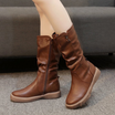 Mid calf boots for women featuring a chunky flat sole and side zip, designed with a stylish slouchy silhouette in vegan leather. 0