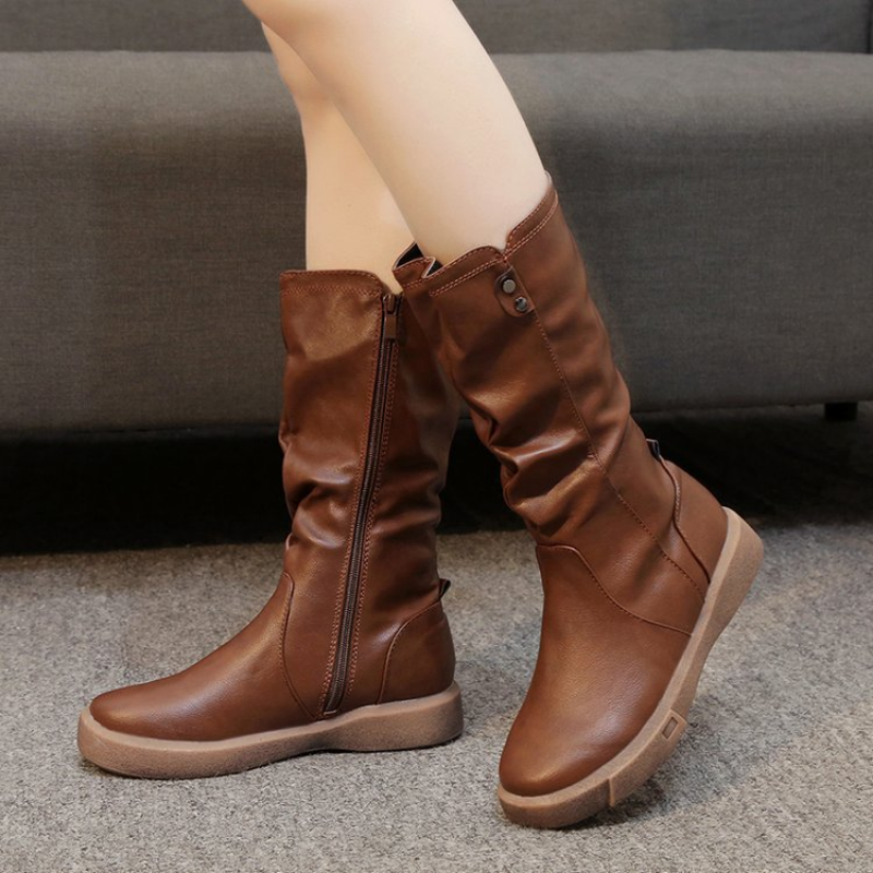 Mid calf boots for women featuring a chunky flat sole and side zip, designed with a stylish slouchy silhouette in vegan leather. 0