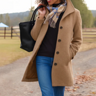 Mid length wool coat for women featuring a high collar, made from warm wool-blend fabric, designed for an elegant fit above the knee. 0