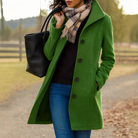 Mid length wool coat for women featuring a high collar, made from warm wool-blend fabric, designed for an elegant fit above the knee. 2