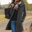 Mid length wool coat for women featuring a high collar, made from warm wool-blend fabric, designed for an elegant fit above the knee. 3
