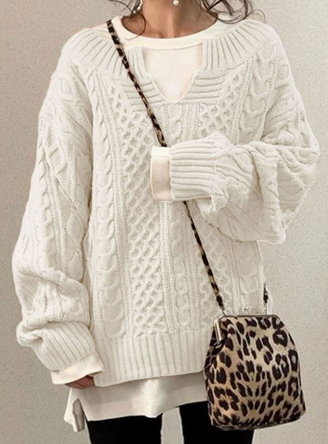 Oversized cable knit sweater with V-neck design, showcasing a cozy hand-knitted texture perfect for women's winter fashion. 1