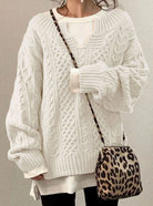 Oversized cable knit sweater with V-neck design, showcasing a cozy hand-knitted texture perfect for women's winter fashion. 1