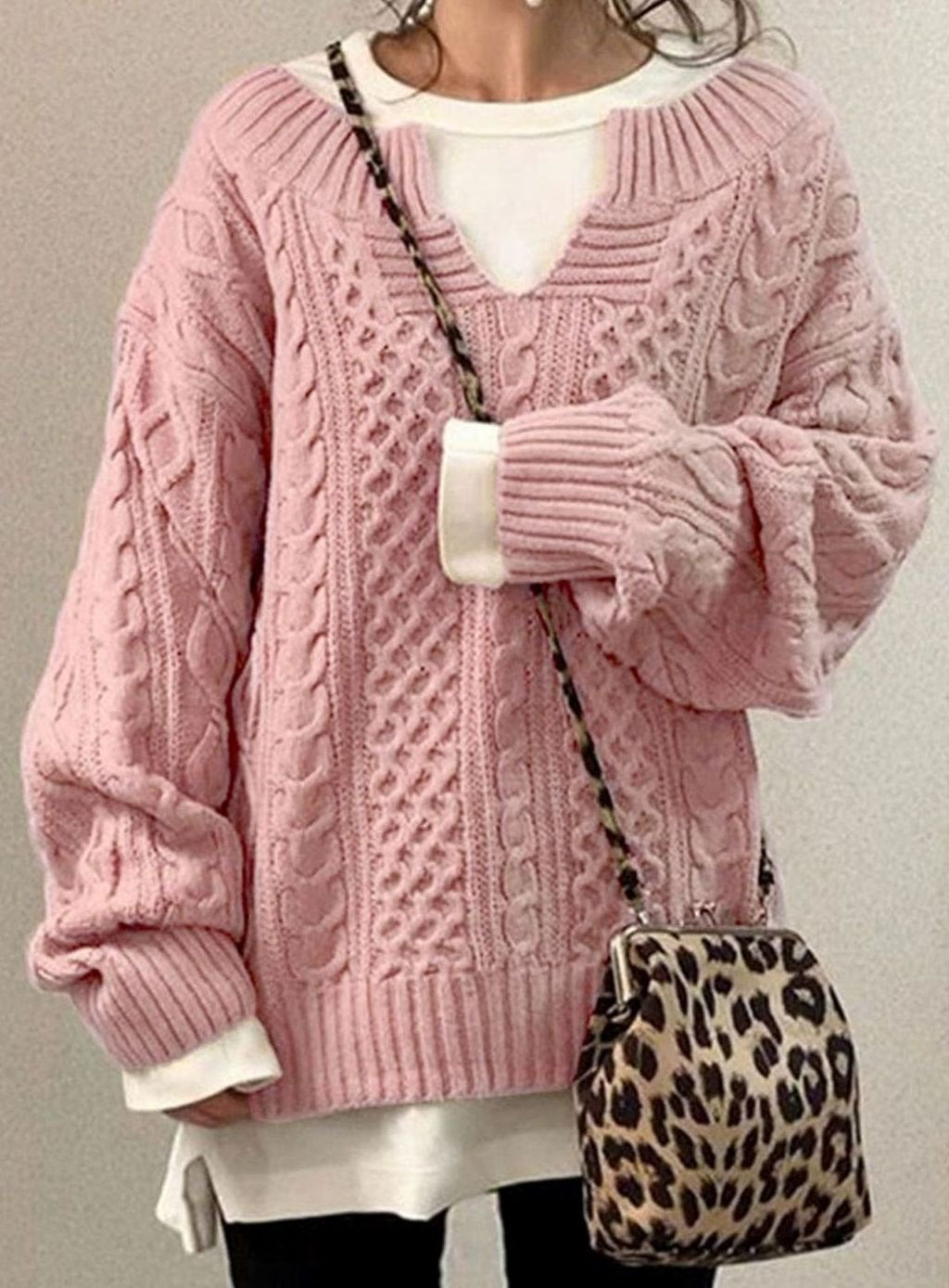 Oversized cable knit sweater with V-neck design, showcasing a cozy hand-knitted texture perfect for women's winter fashion. 3