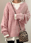 Oversized cable knit sweater with V-neck design, showcasing a cozy hand-knitted texture perfect for women's winter fashion. 3