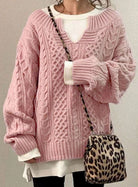 Oversized cable knit sweater with V-neck design, showcasing a cozy hand-knitted texture perfect for women's winter fashion. 3