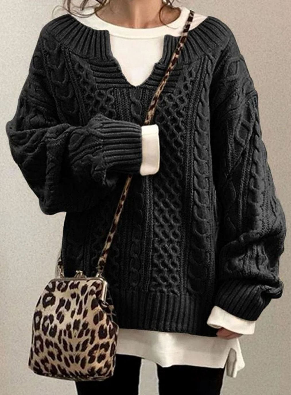Oversized cable knit sweater with V-neck design, showcasing a cozy hand-knitted texture perfect for women's winter fashion. 4