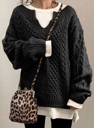 Oversized cable knit sweater with V-neck design, showcasing a cozy hand-knitted texture perfect for women's winter fashion. 4