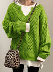 Oversized cable knit sweater with V-neck design, showcasing a cozy hand-knitted texture perfect for women's winter fashion. 5