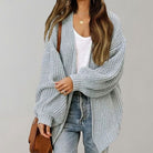 Oversized chunky knit cardigan with balloon sleeves, featuring a soft open front design, perfect for women's layering in cool weather. 2