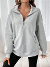 Oversized women's hoodie with a half zip collar and kangaroo pocket, made from soft fleece for a cozy casual look. 0
