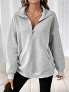 Oversized women's hoodie with a half zip collar and kangaroo pocket, made from soft fleece for a cozy casual look. 0