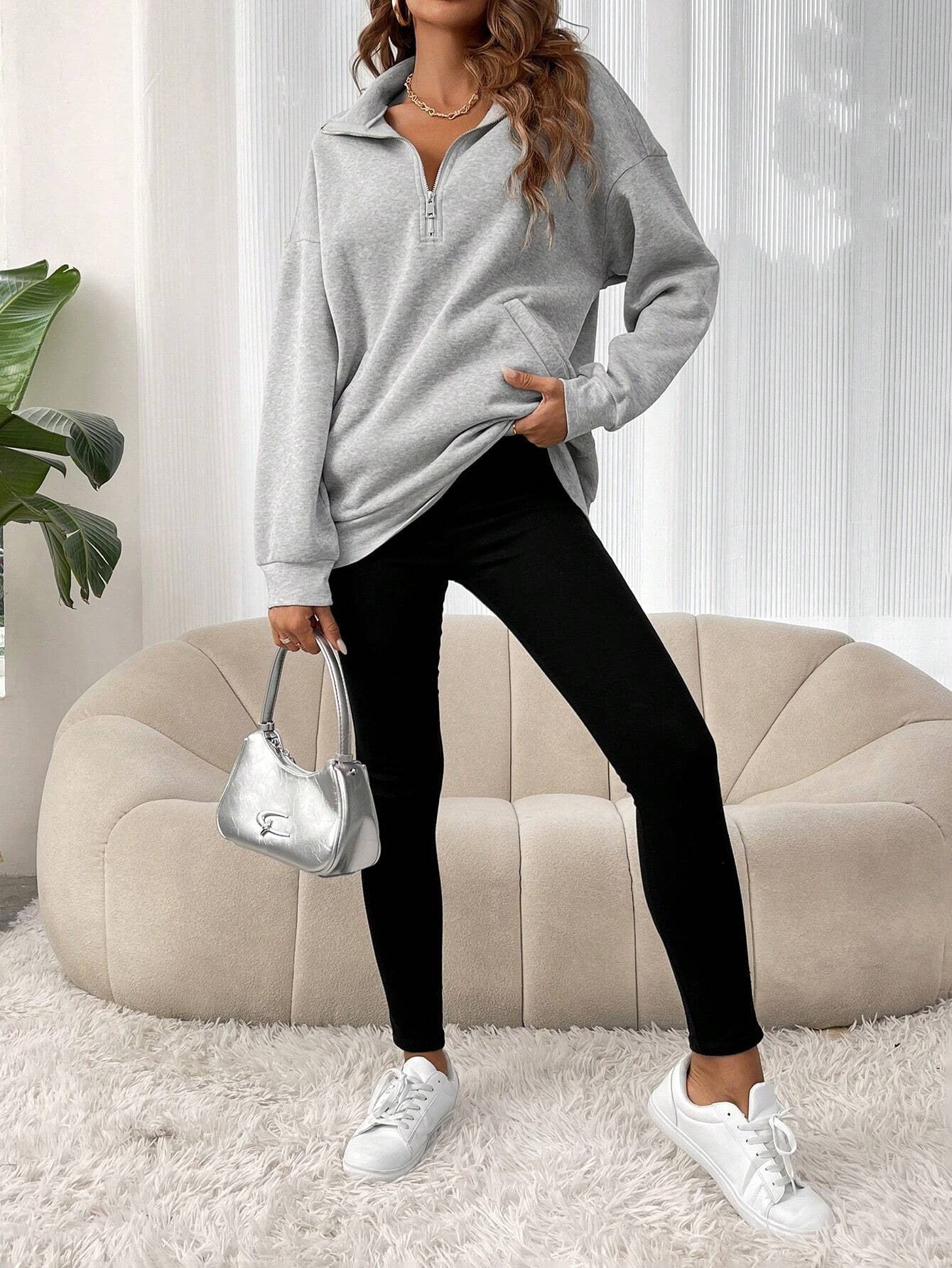 Oversized women's hoodie with a half zip collar and kangaroo pocket, made from soft fleece for a cozy casual look. 1