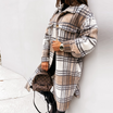 Oversized plaid shacket featuring a button front and chest pockets, designed for women, perfect for casual layering in a wool-style fabric. 0
