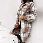 Oversized plaid shacket featuring a button front and chest pockets, designed for women, perfect for casual layering in a wool-style fabric. 0