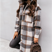 Oversized plaid shacket featuring a button front and chest pockets, designed for women, perfect for casual layering in a wool-style fabric. 1